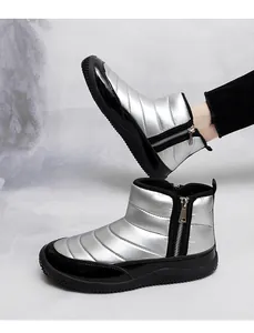 Detail of silver metallic snow boots with side zipper and thick black rubber sole
