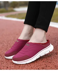 Close-up of burgundy winter mule slippers with warm lining and sport sole detail