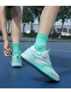 Close-up of breathable mesh training shoes with a quick-lace rotary knob system