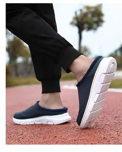 Detail of warm navy plush lining and thick anti-slip white sole on winter slippers