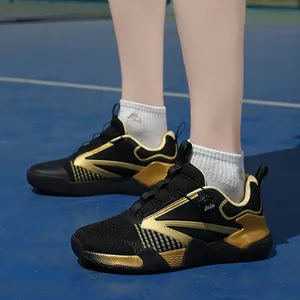 Black and gold breathable training sports shoes with quick lace system on blue court