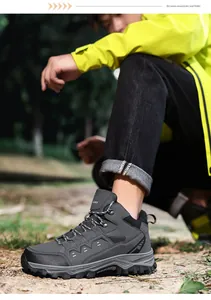 Detailed side view of dark grey hiking boots with durable rubber soles for outdoor trekking