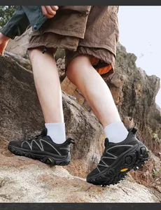 Detail of durable outdoor hiking shoe with non-slip rubber sole climbing on rocks