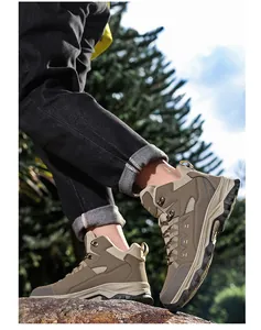 Close-up of durable rubber outsole with deep lugs on khaki outdoor hiking boots