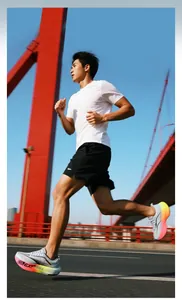 Dynamic low-angle shot of breathable mesh running shoes with vibrant gradient cushioned soles