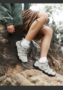 Outdoor hiking shoes on rocky terrain showing durable rubber soles and quick-lace system