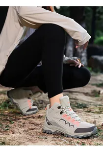 Close-up of hiking boots showing durable fabric, orange webbing, and anti-slip rubber soles