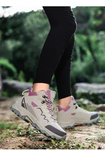 Detail shot of high-top hiking boots with non-slip rubber soles and durable laces