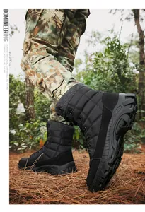 Close-up of durable high-top men's tactical boots with anti-slip rubber outsoles in forest