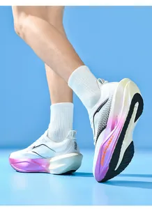 Close-up of white breathable mesh sneaker with pink gradient cushioned thick sole