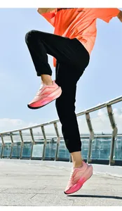 Dynamic low-angle shot of breathable mesh running shoes with pink gradient cushioned soles