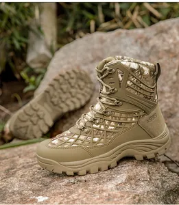 Detail of high-top tactical boot with khaki camouflage pattern on a rocky outdoor terrain