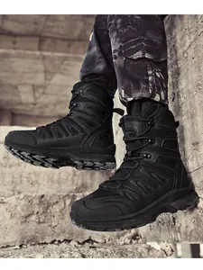 Detail of high-top black tactical boots with durable rubber soles on concrete steps