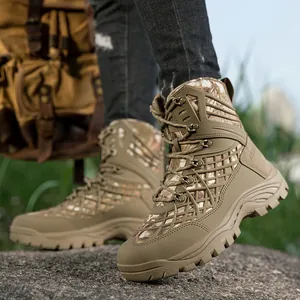 Camouflage high-top tactical outdoor boots with rugged rubber soles on rocky terrain