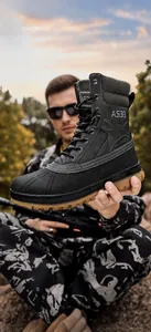 Detail view of high-top tactical boots with anti-slip rubber soles and AS33 side lettering