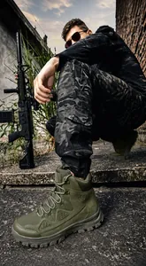 Detail of A533 green tactical boots with thick rubber soles on outdoor terrain