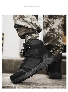 Detail of black tactical hiking boots with mesh fabric and reinforced rubber sole