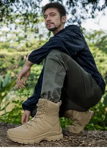 Detail view of khaki tactical hiking boots with non-slip rubber sole in outdoor jungle