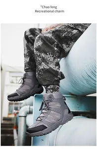 Detail of grey tactical hiking boots with non-slip soles worn with camouflage pants