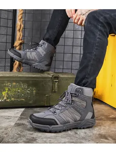 Close-up of grey tactical outdoor boots with breathable mesh and anti-slip rubber soles