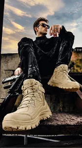 Outdoor low-angle shot of sand high-top tactical boots with side zippers and lug soles