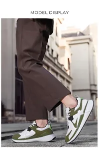 Classic outdoor men's sneakers in olive green and white styled on city street