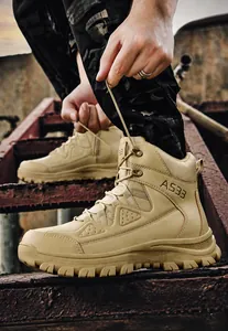 Detail of khaki tactical boots with thick lug soles showing AS33 logo and durability