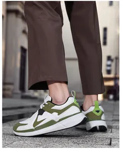 On-foot view of white men's sneakers with olive green accents and durable rubber soles
