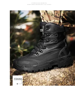 Detail of black tactical combat boots with thick rubber soles on rocky outdoor terrain