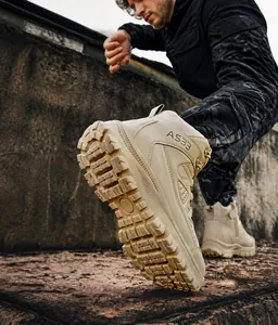 Detailed view of sand tactical boots with high-traction rubber soles for hiking