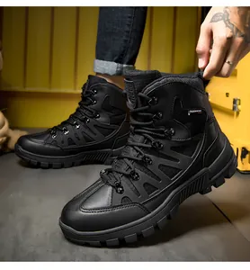 Low-angle side view of black mid-top tactical boots with anti-slip rubber soles and quick lacing