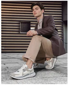 Detail view of men's chunky sneakers with multi-material paneling and thick cushioned soles
