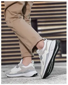 Detail of grey and white mesh paneling on men's chunky casual sneakers outdoor