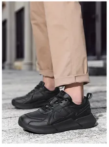 Close-up of black men's casual sneakers featuring breathable perforated synthetic leather