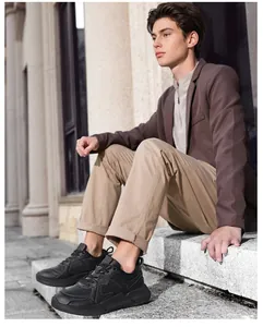 Close-up of black men's casual sneakers with thick cushioned soles and layered textures