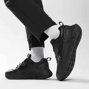 Classic all-black men's athletic sneakers in premium synthetic leather with low-top design