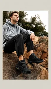 Detail view of black outdoor hiking boots with traction soles for rugged mountain terrain