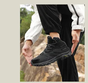 Detail of breathable outdoor hiking boots on rocks featuring rugged rubber outsoles