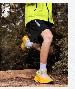 Detail of multi-color trail running shoes with thick cushioning sole for outdoor hiking