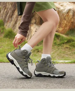 Detailed outdoor shot of army green hiking boots with breathable mesh and suede upper