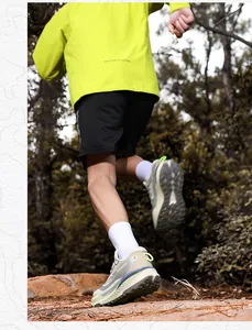 Outdoor trail running shoes with thick cushioning soles shown in an active forest setting