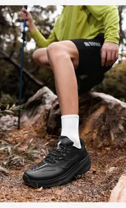 Outdoor black trekking sneakers with cushioned soles shown in a forest trail setting