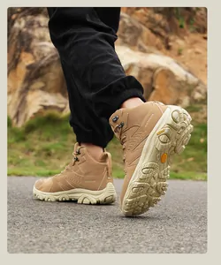 Detail of khaki high-top hiking boots with thick non-slip soles on outdoor mountain trails