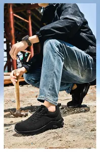 Detail of black safety shoe with rotary dial lacing and air cushion on a construction site