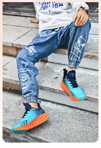 Detail view of breathable blue and orange mesh running shoes on outdoor stone steps