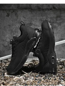 Detail of black safety shoes with breathable knit upper, rotary buckle, and air cushion