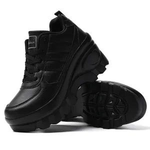 Detail of black platform sneakers with leather texture and thick anti-slip lug sole
