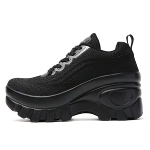 Dettaglio di sneaker nere con plateau in rete traspirante e rilievo a forma di cuore