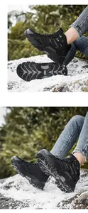 Detailed view of durable black outdoor boots with deep anti-slip rubber treads on snow