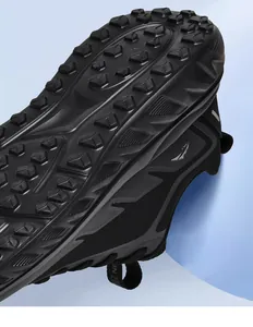 Macro shot of deep tread outsole and breathable mesh upper on black trail running shoes